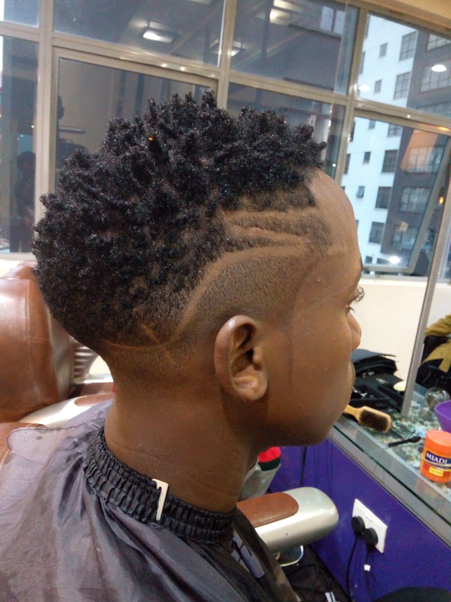 Barber fade with custom design at Leo's Salon